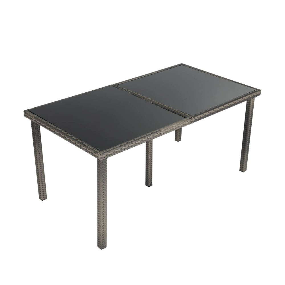 Grey wicker outdoor dining table with dark tabletop and sturdy corner posts
