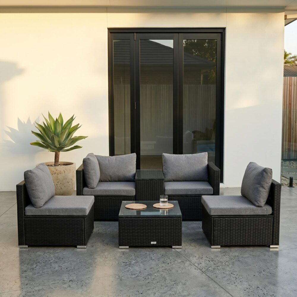Outdoor wicker lounge set with gray cushions and dark wicker seats, with square glass coffee table