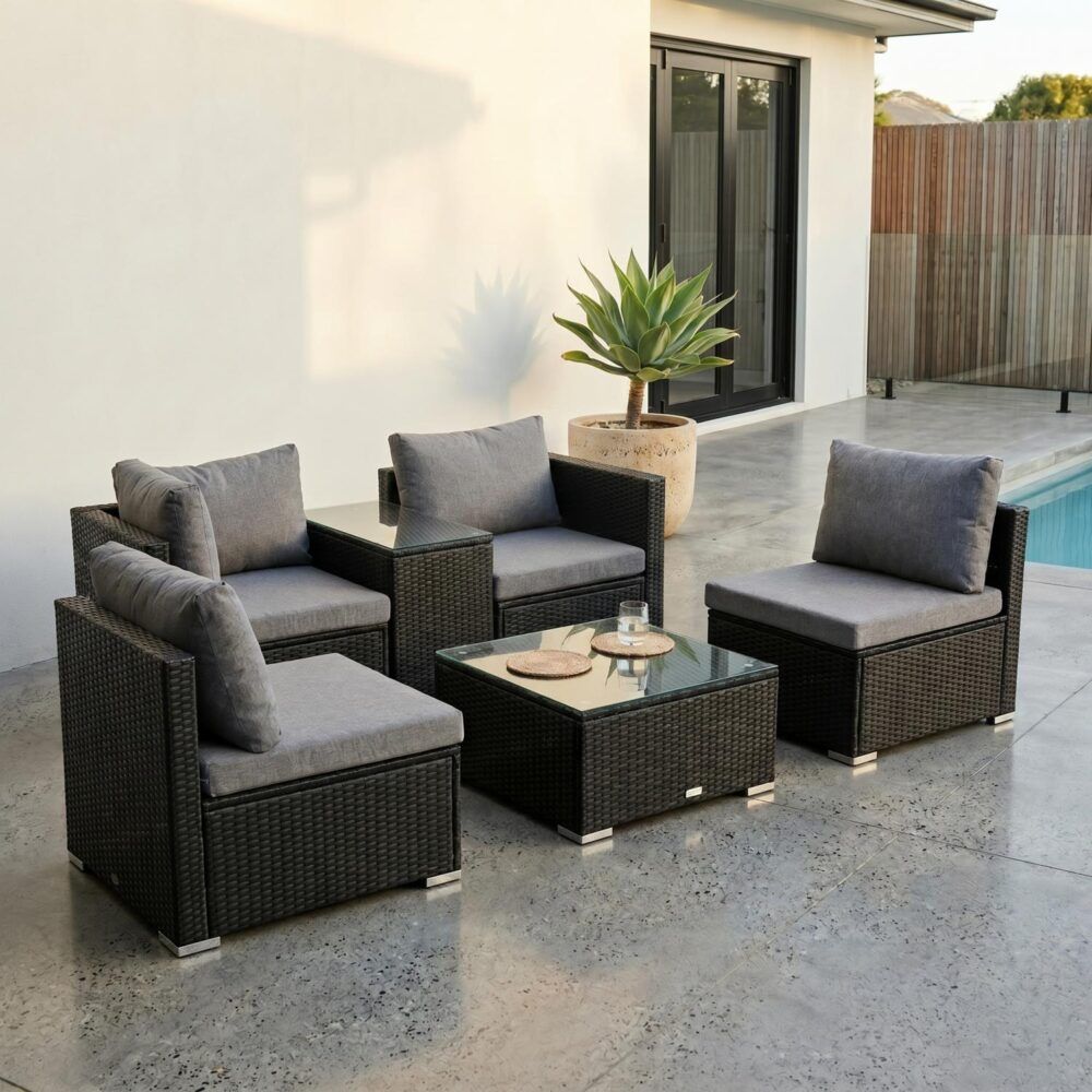 Outdoor wicker lounge set with gray cushions, dark wicker seats, and square glass coffee table