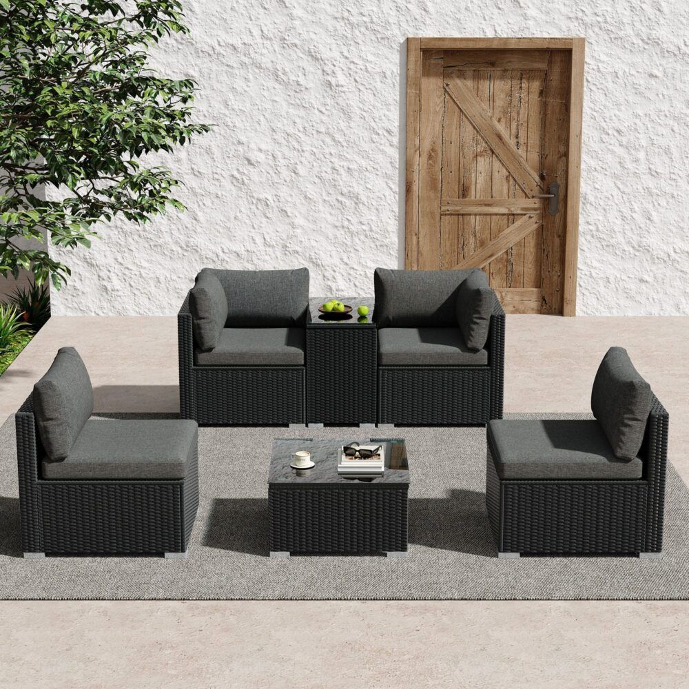 Modular wicker lounge corner set with gray seat cushions, four dark armchairs, and low coffee table