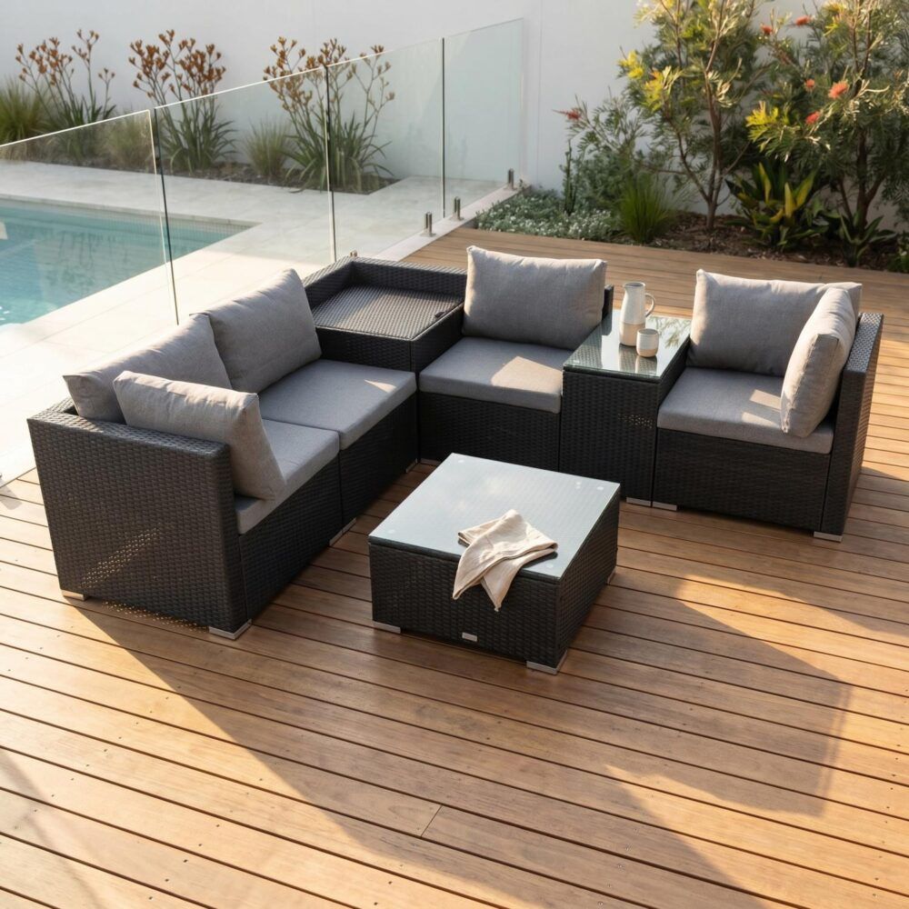 Black outdoor wicker corner loveseat with grey cushions and storage ottoman table