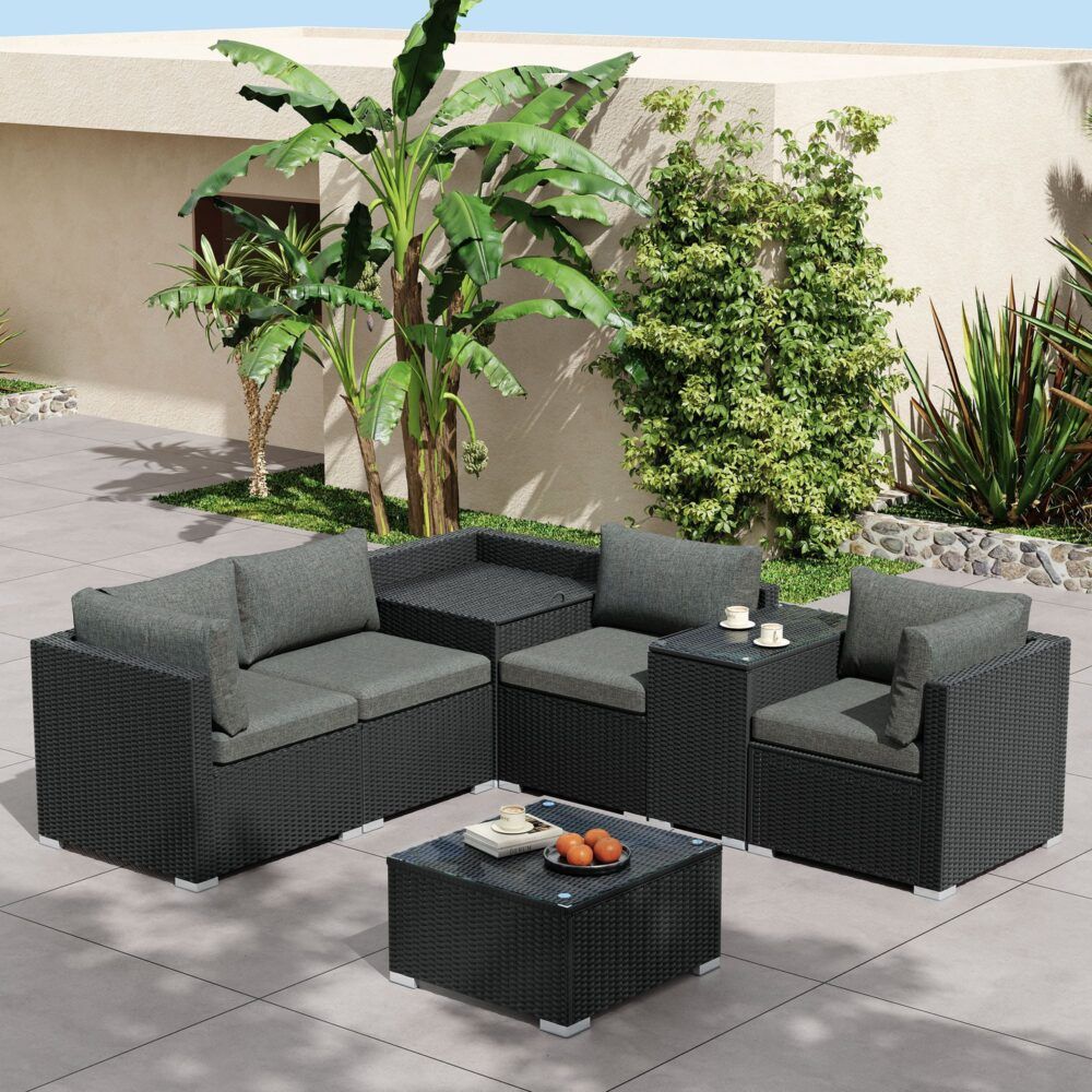 Black wicker outdoor sectional set with grey seat cushions and storage coffee table
