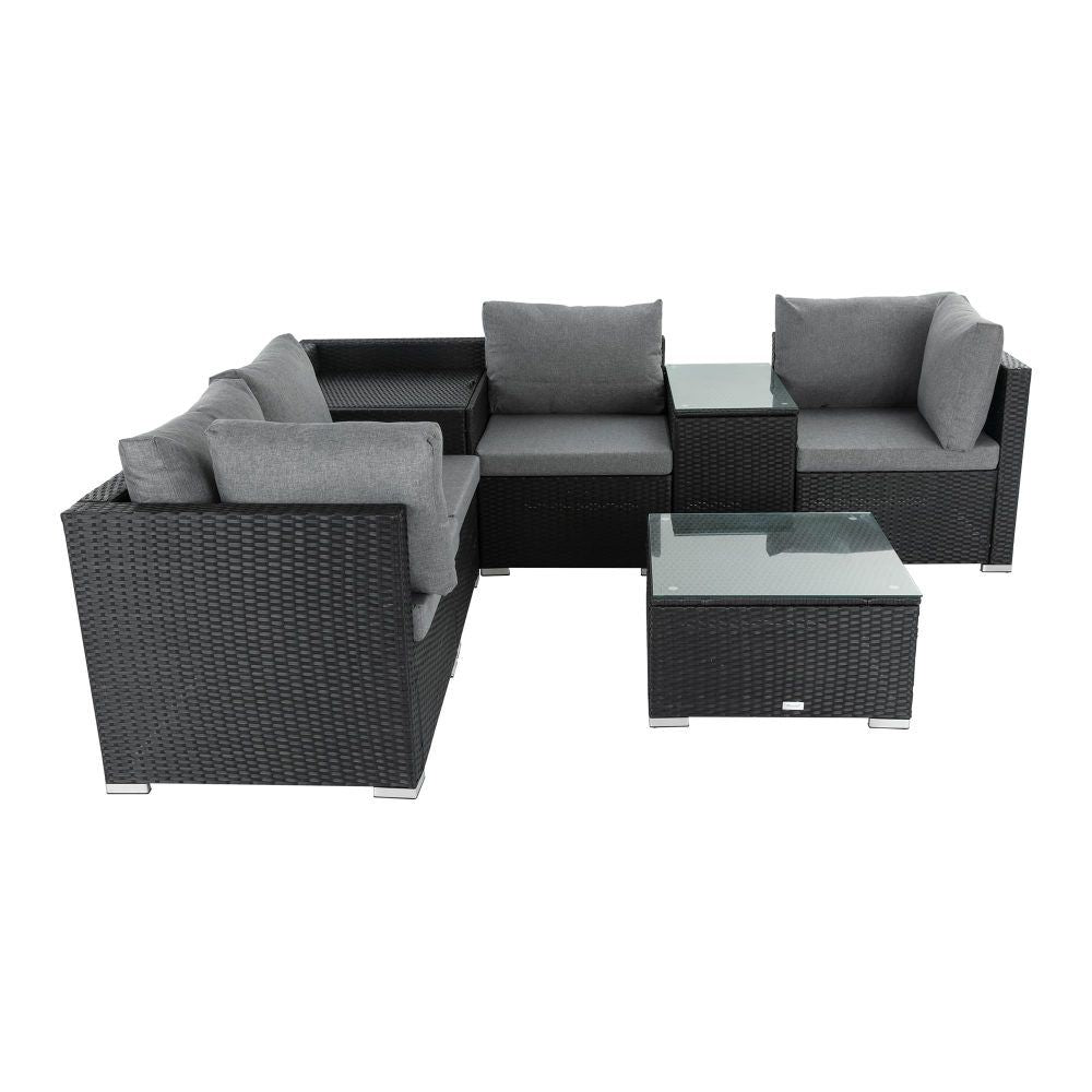 Black wicker corner outdoor sofa with grey cushions and square glass storage table