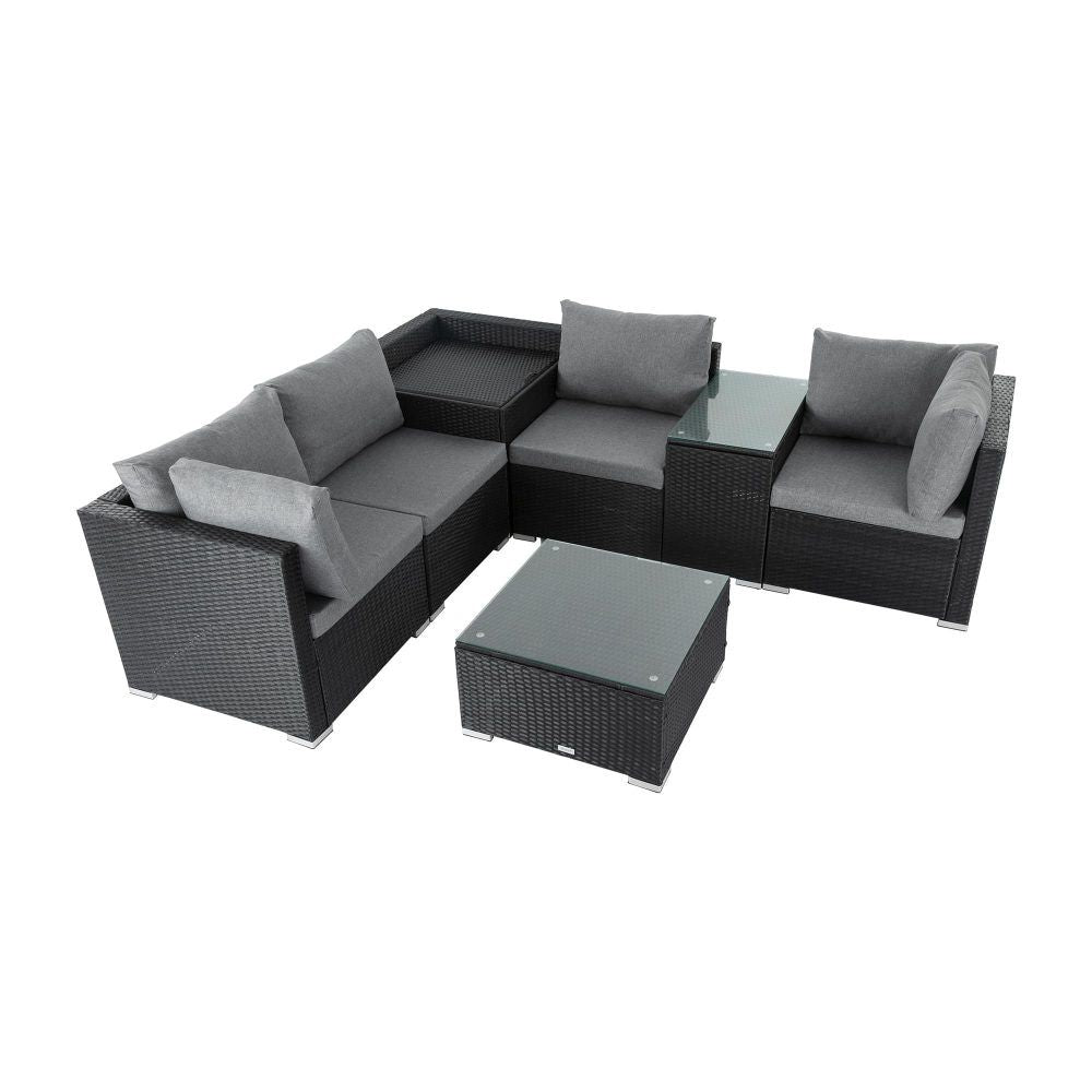 Black wicker sectional corner with grey cushions and square glass coffee table