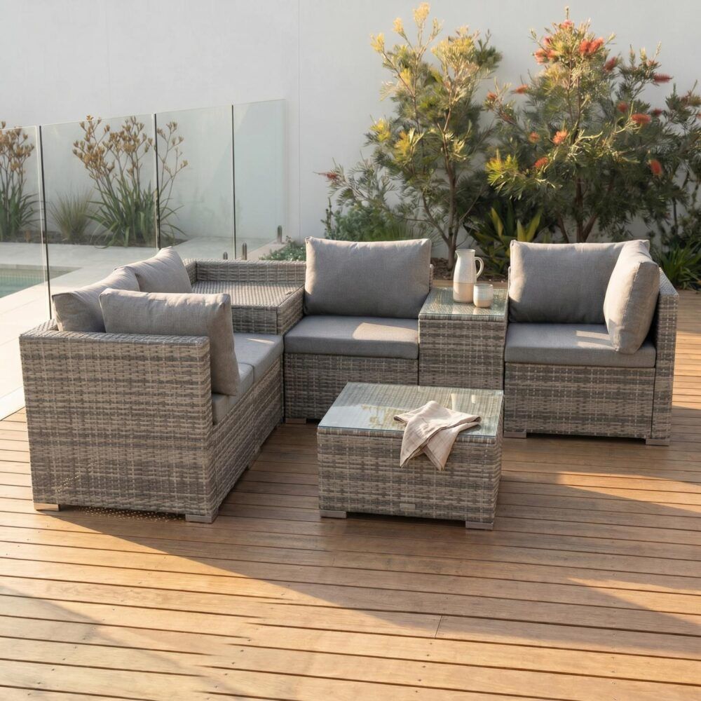 Grey outdoor wicker lounge set corner section with grey cushions and square glass-top coffee table