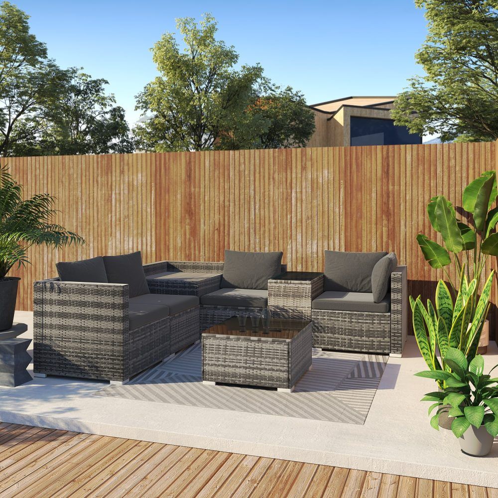 Grey outdoor wicker lounge set with corner seating and square coffee table on outdoor patio