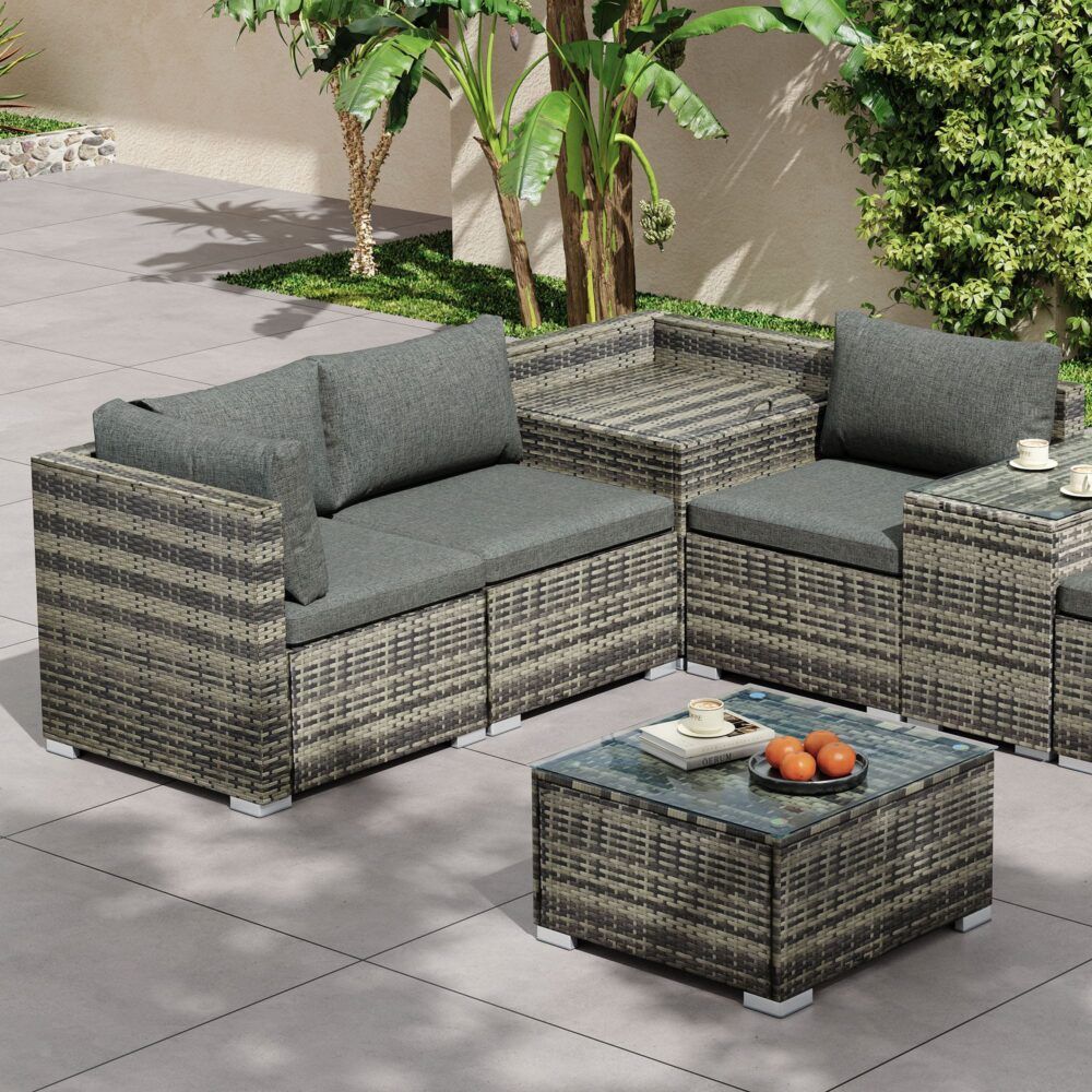 Grey outdoor wicker corner lounge set with storage ottoman and glass-top coffee table