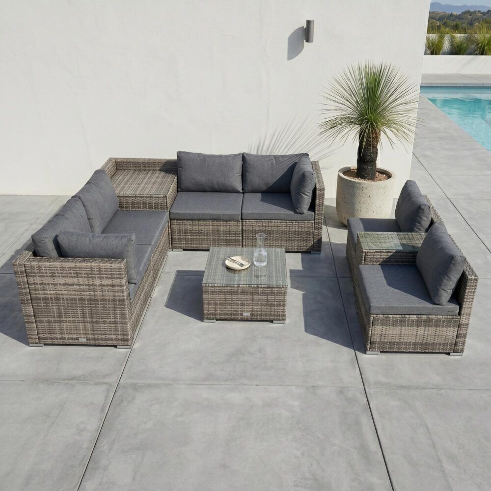 Outdoor patio seating set with gray cushions, corner sectional sofa, and two armchairs