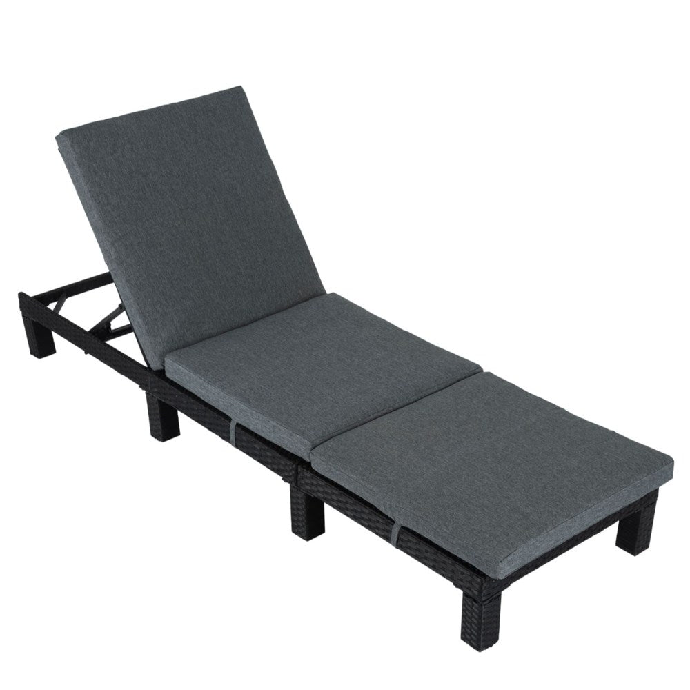 Adjustable rattan sunbed with dark frame and gray cushions, backrest angled