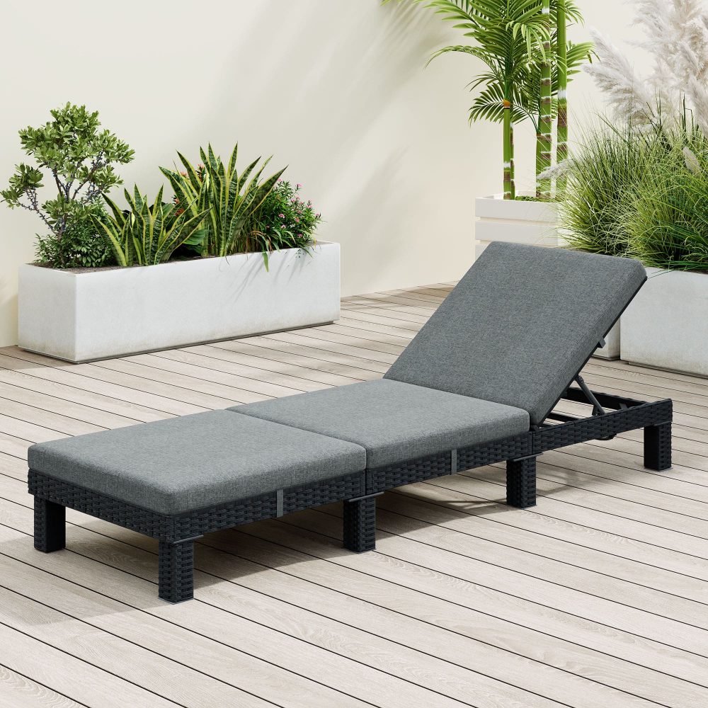 Outdoor rattan sunbed with dark frame and gray cushions, adjustable backrest