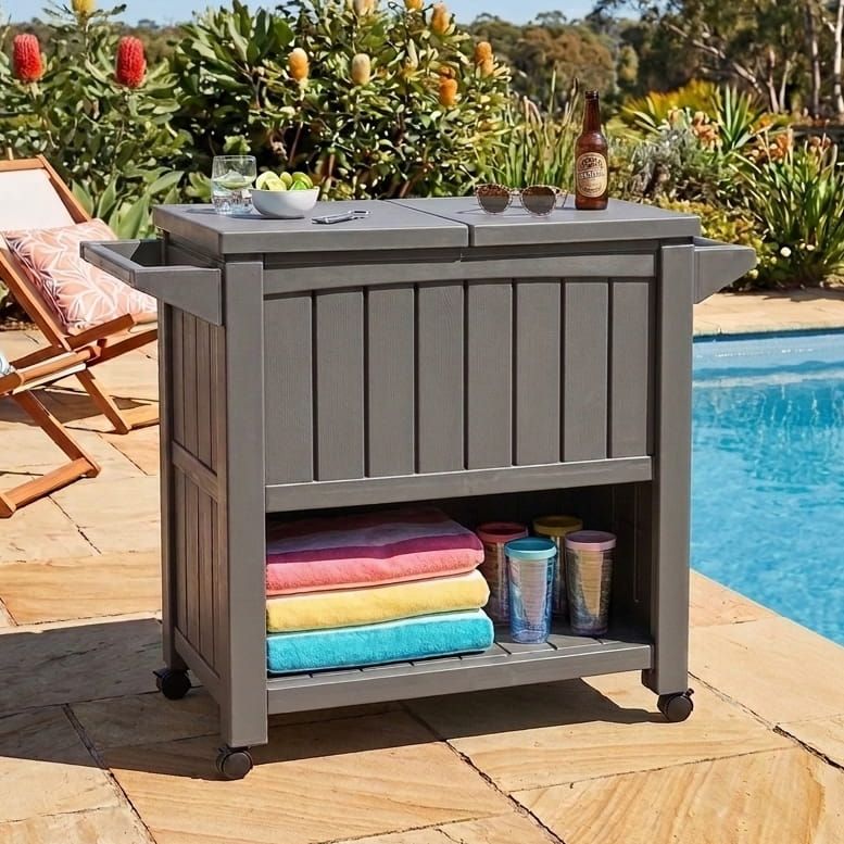 Taupe outdoor bar serving cart with cooler, side shelf, and open storage on wheels