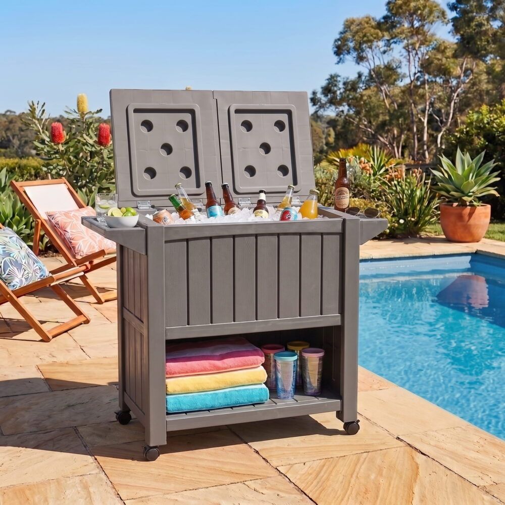 Taupe outdoor bar cart with cooler, dual lid compartments, and lower shelf on wheels