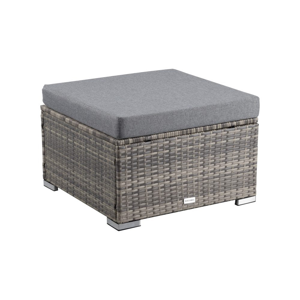 Grey outdoor wicker ottoman with square cushion, woven texture and low black legs.