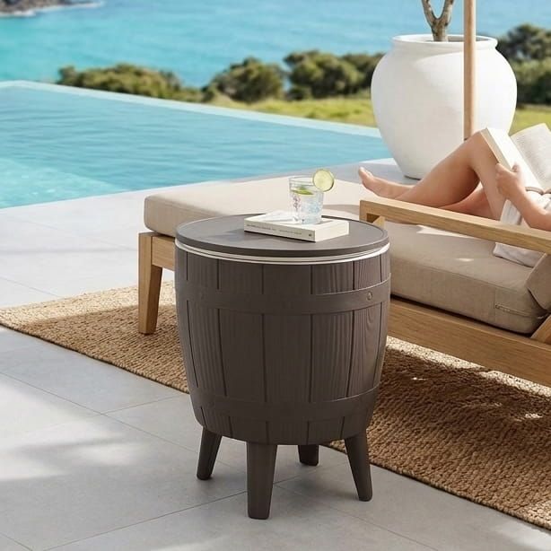 Taupe round cooler table with ice bucket insert and four short legs.