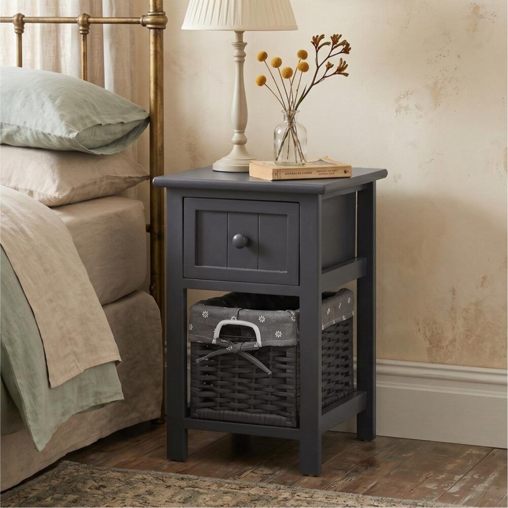 Grey bedside table with front drawer and open wicker storage basket, top shelf included.
