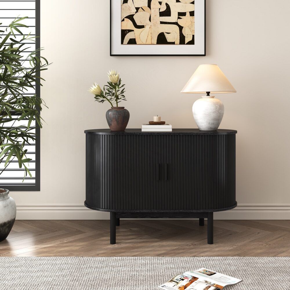 Black ribbed sideboard cabinet on four legs with vertical slat doors and curved top
