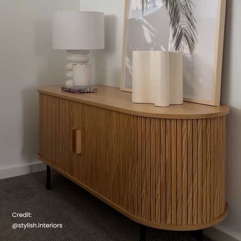 Ripple sideboard with sliding doors, warm light wood slats, inset handles, tapered dark legs