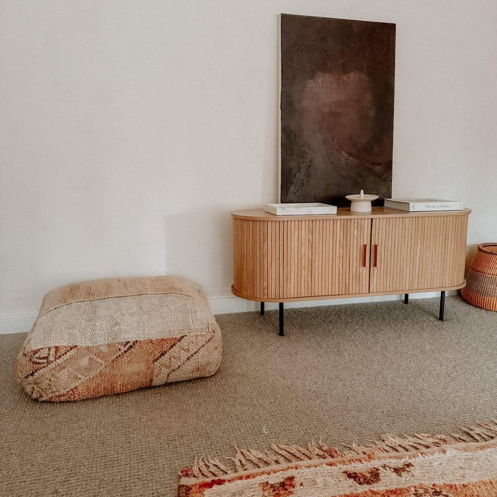 Ripple sideboard with sliding doors, light wood slat finish, bar handles, dark legs