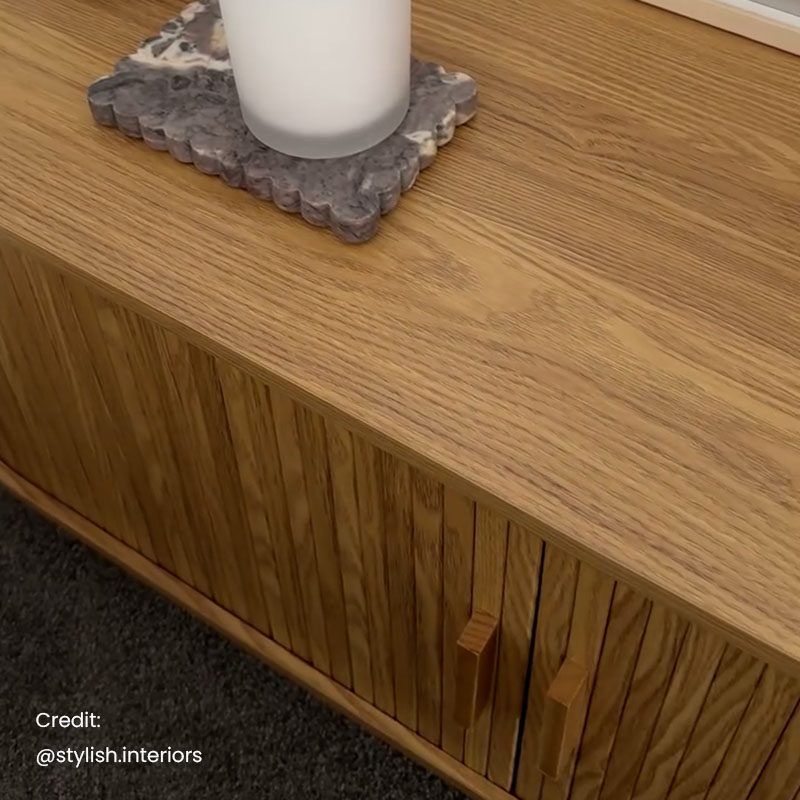 Ripple sideboard with sliding doors, close-up of light wood slat panel edge and dark legs