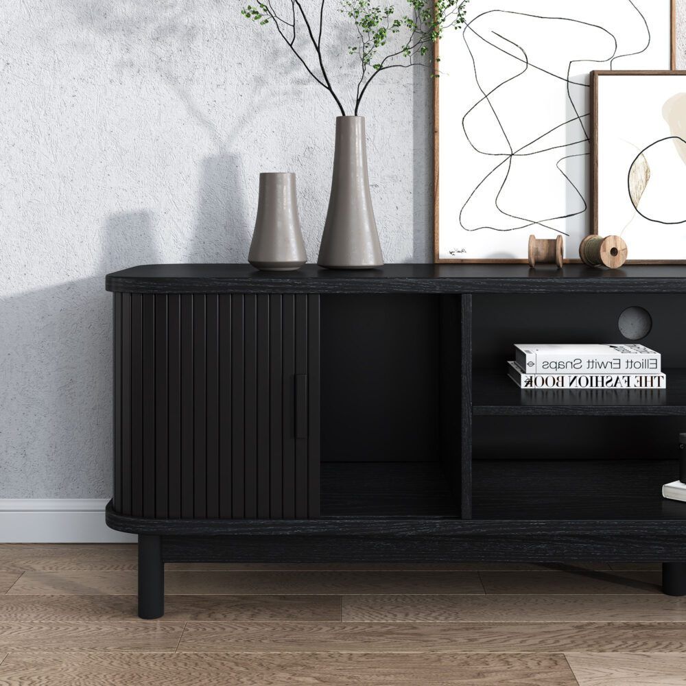 Ribbed black cabinet and open shelf on a black entertainment unit