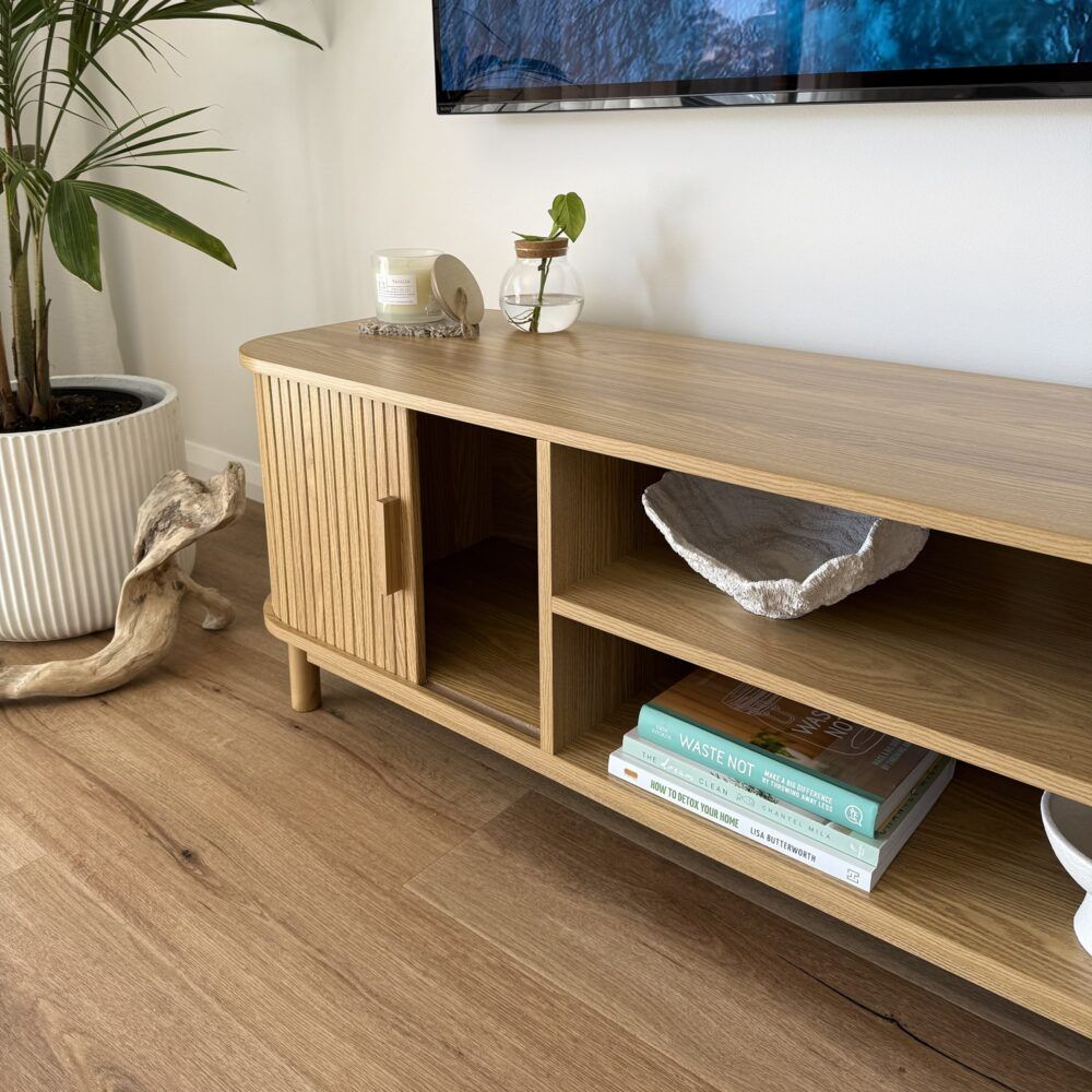Light wood TV entertainment unit with open center shelves and ribbed side panels