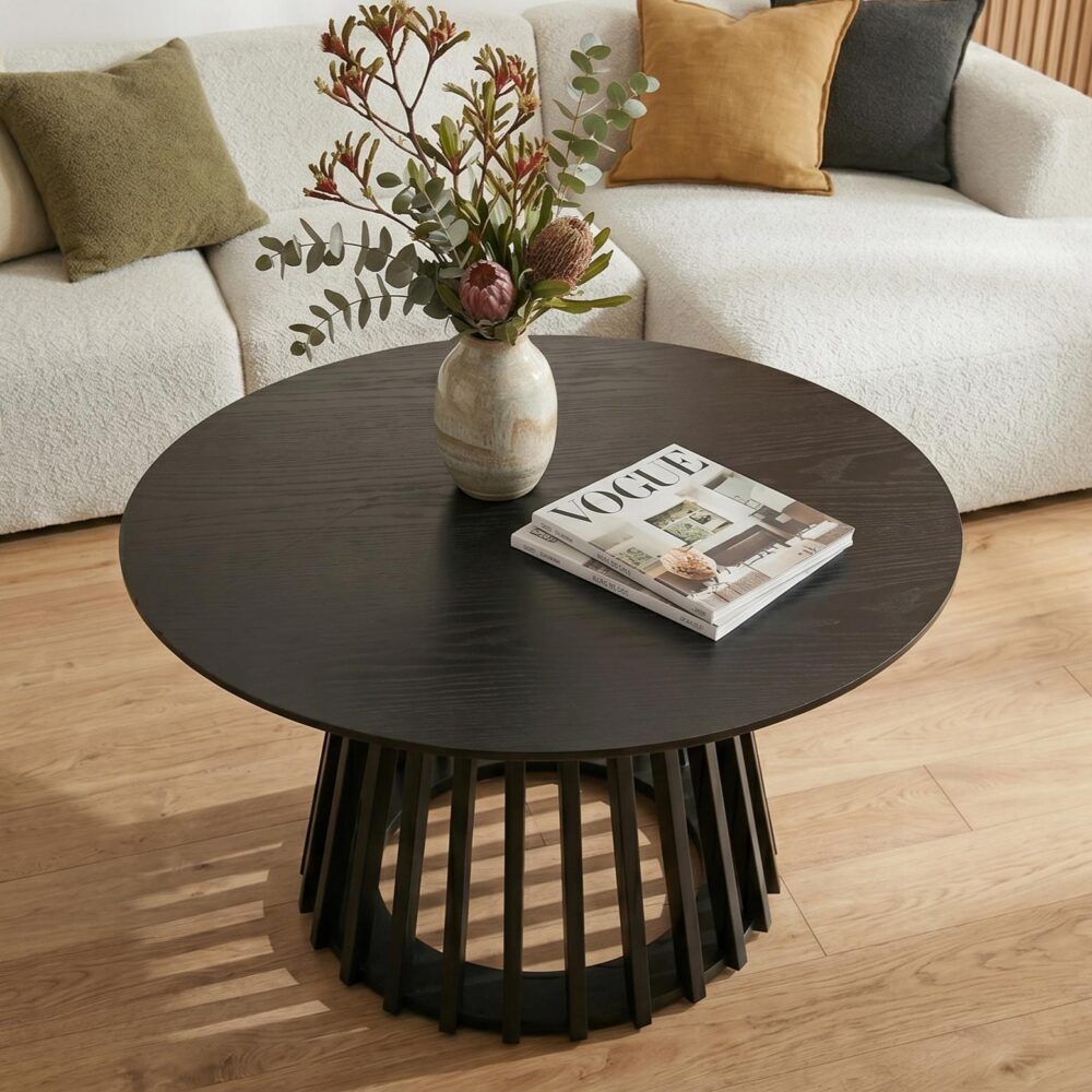Round dark wood coffee table with slatted pedestal base and wide tabletop.