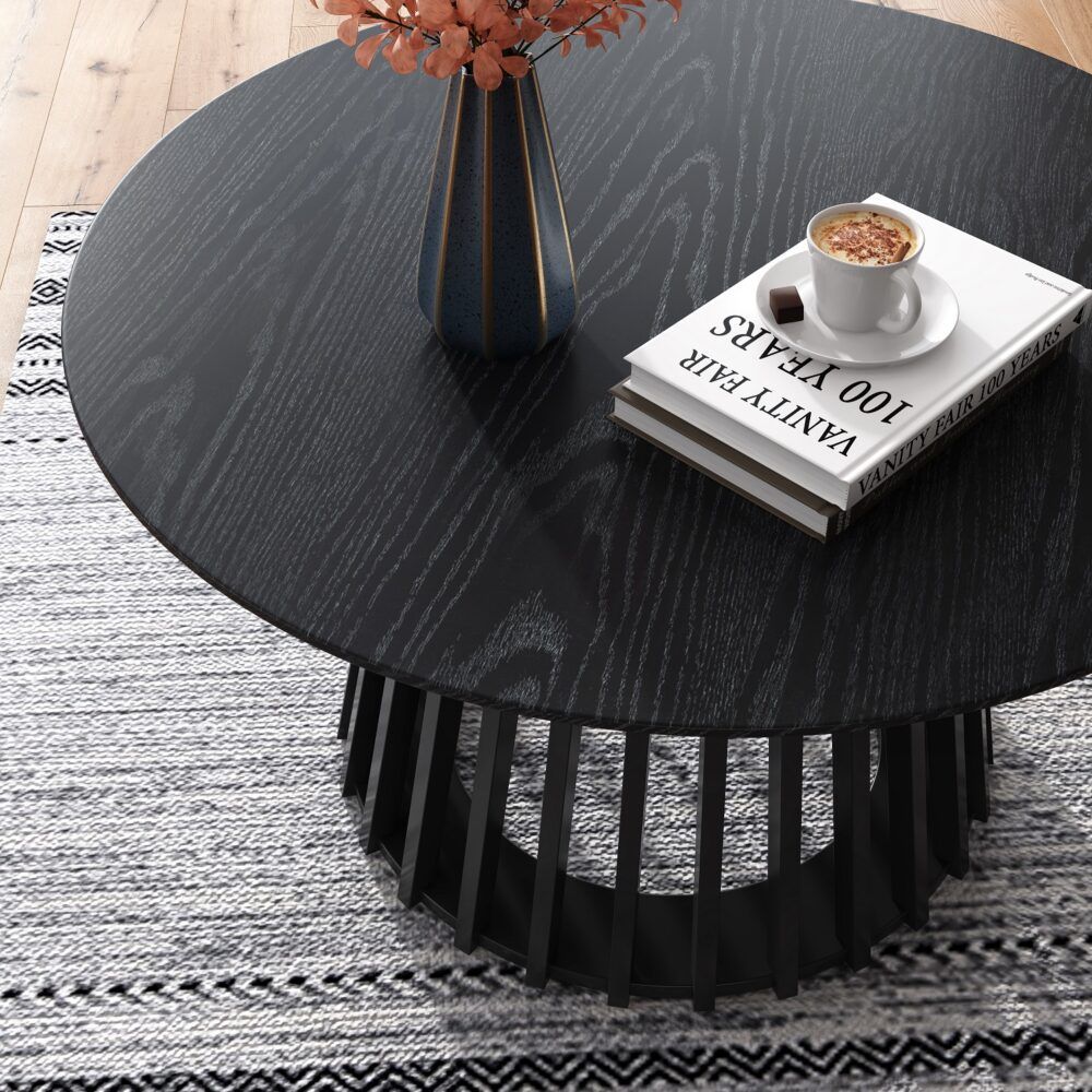 Round dark wood coffee table top with striped woodgrain and slatted base legs.