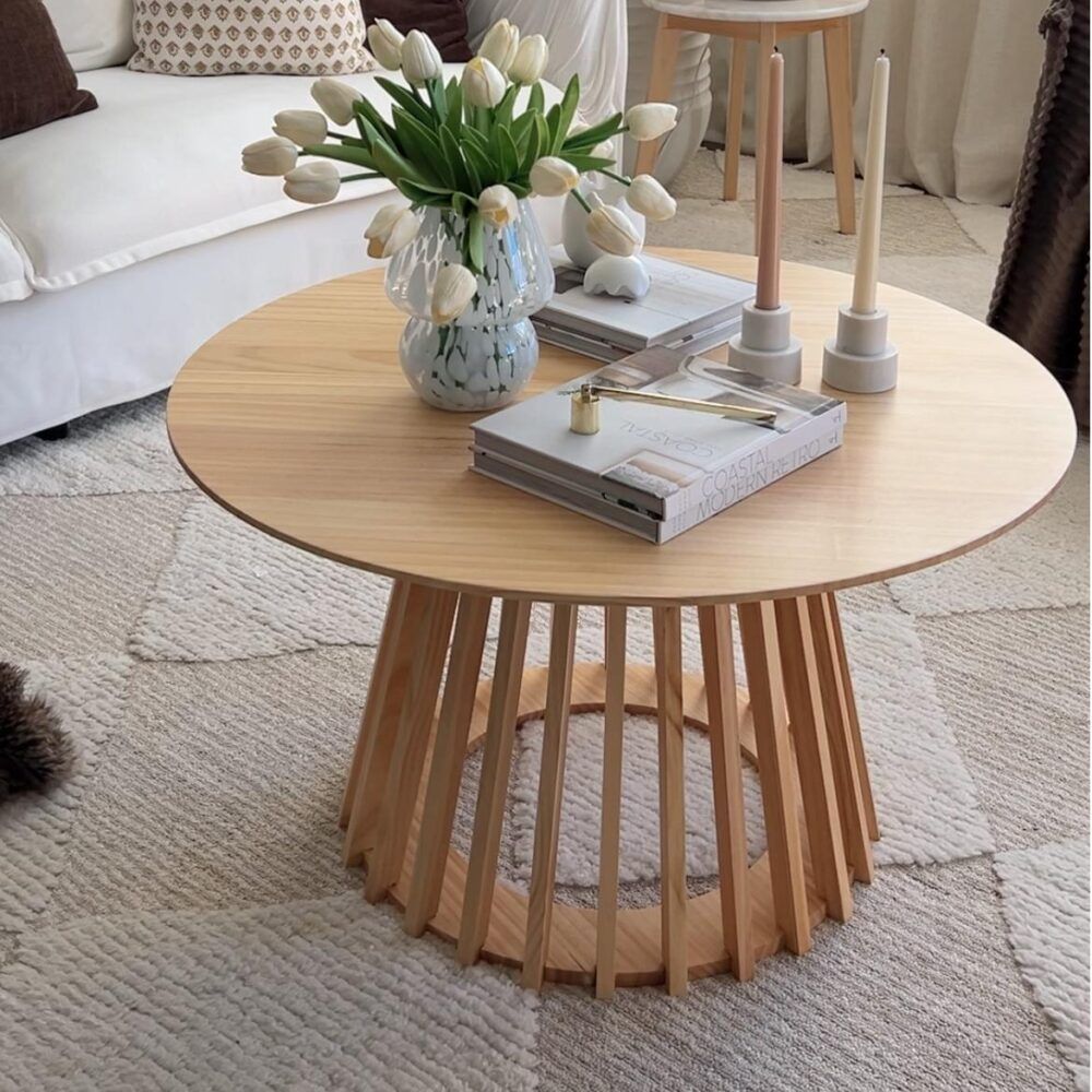 Round natural wood coffee table with slatted legs and round tabletop