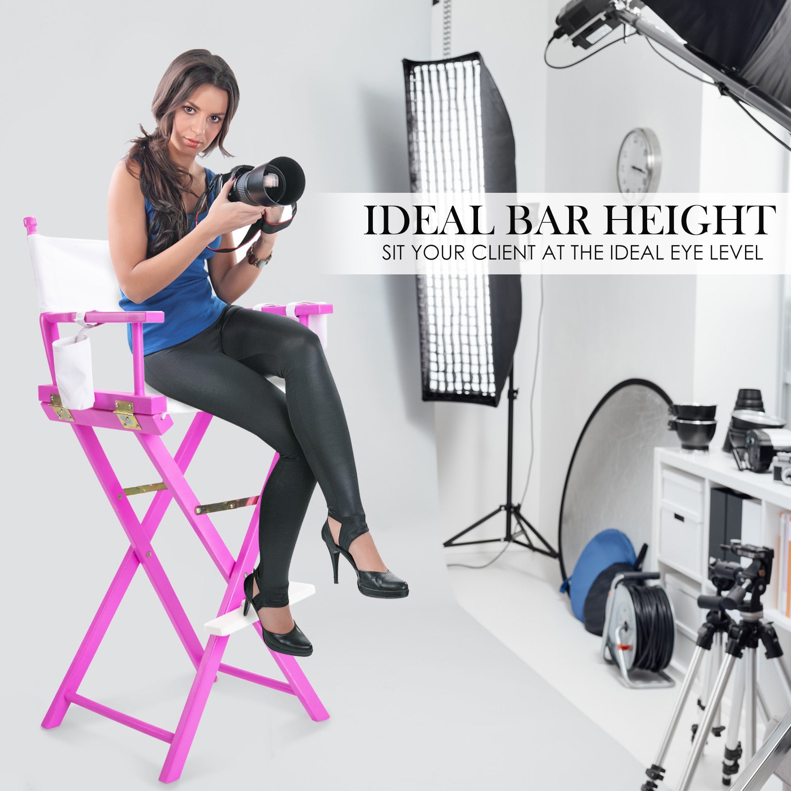 Pink folding tall director chair with white seat, photographed in studio with a person