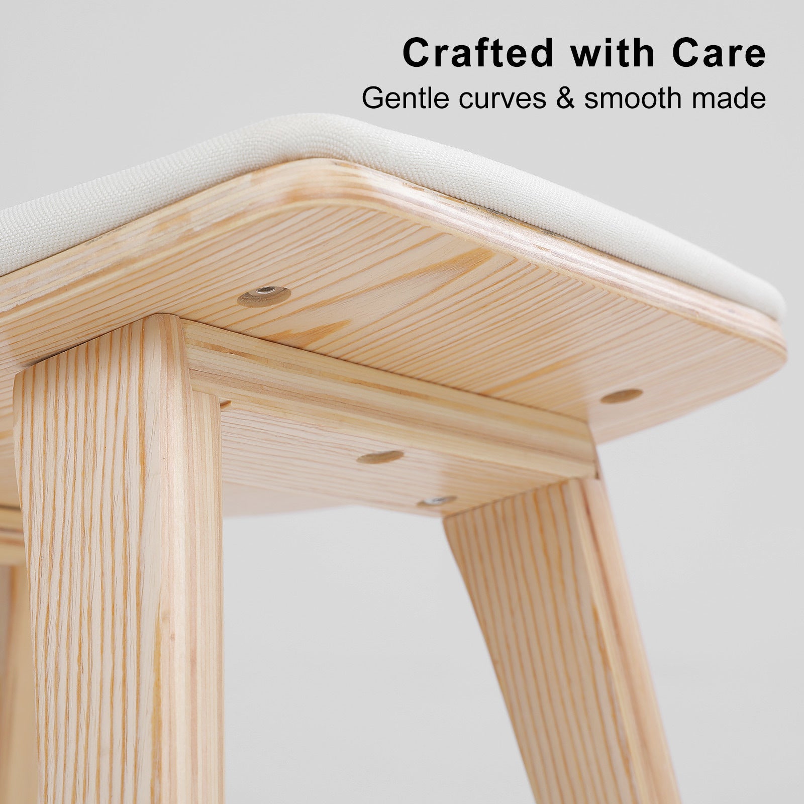 Wooden bar stool corner with beige fabric padded seat and smooth rounded edges