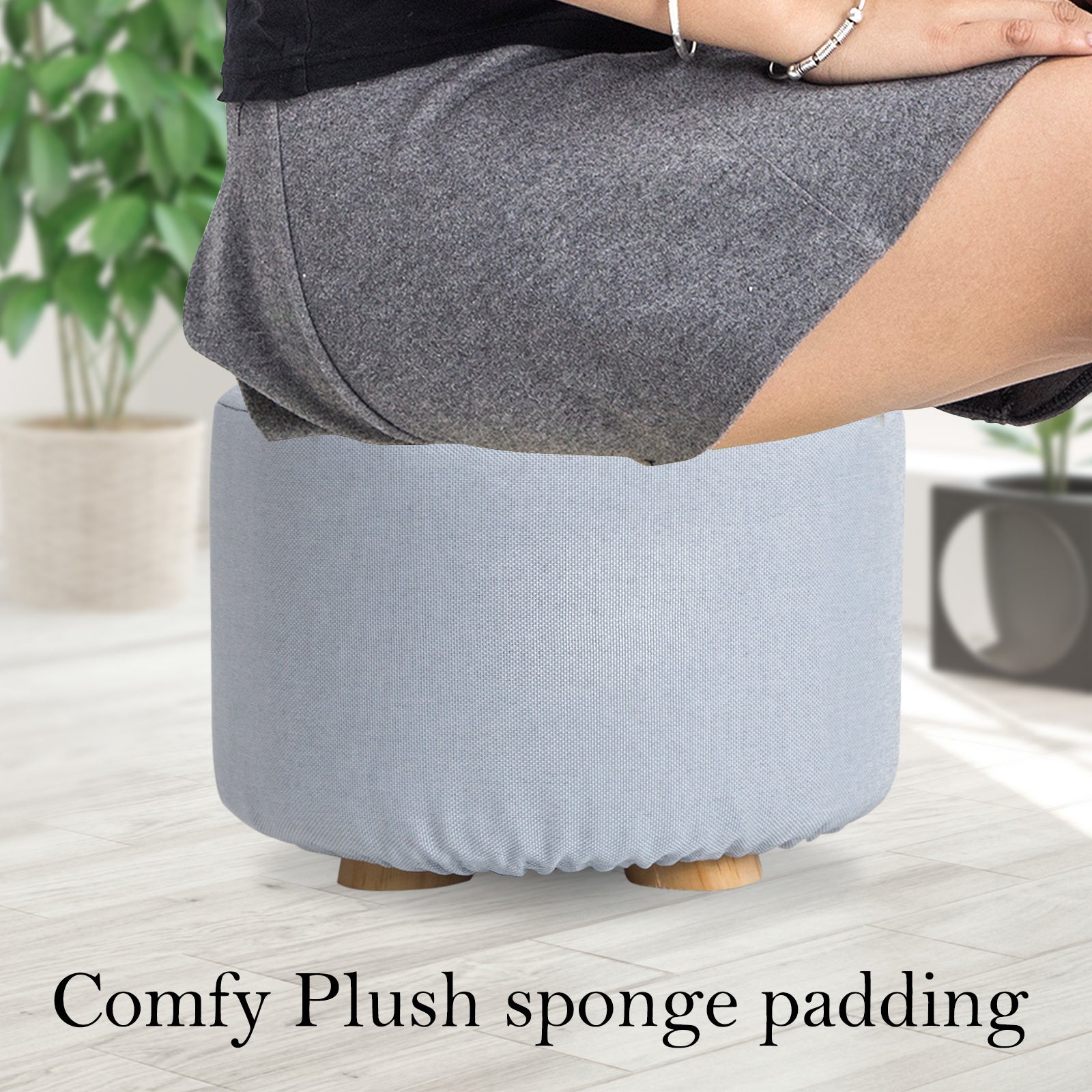 Light blue round fabric ottoman foot stool with plush padded base