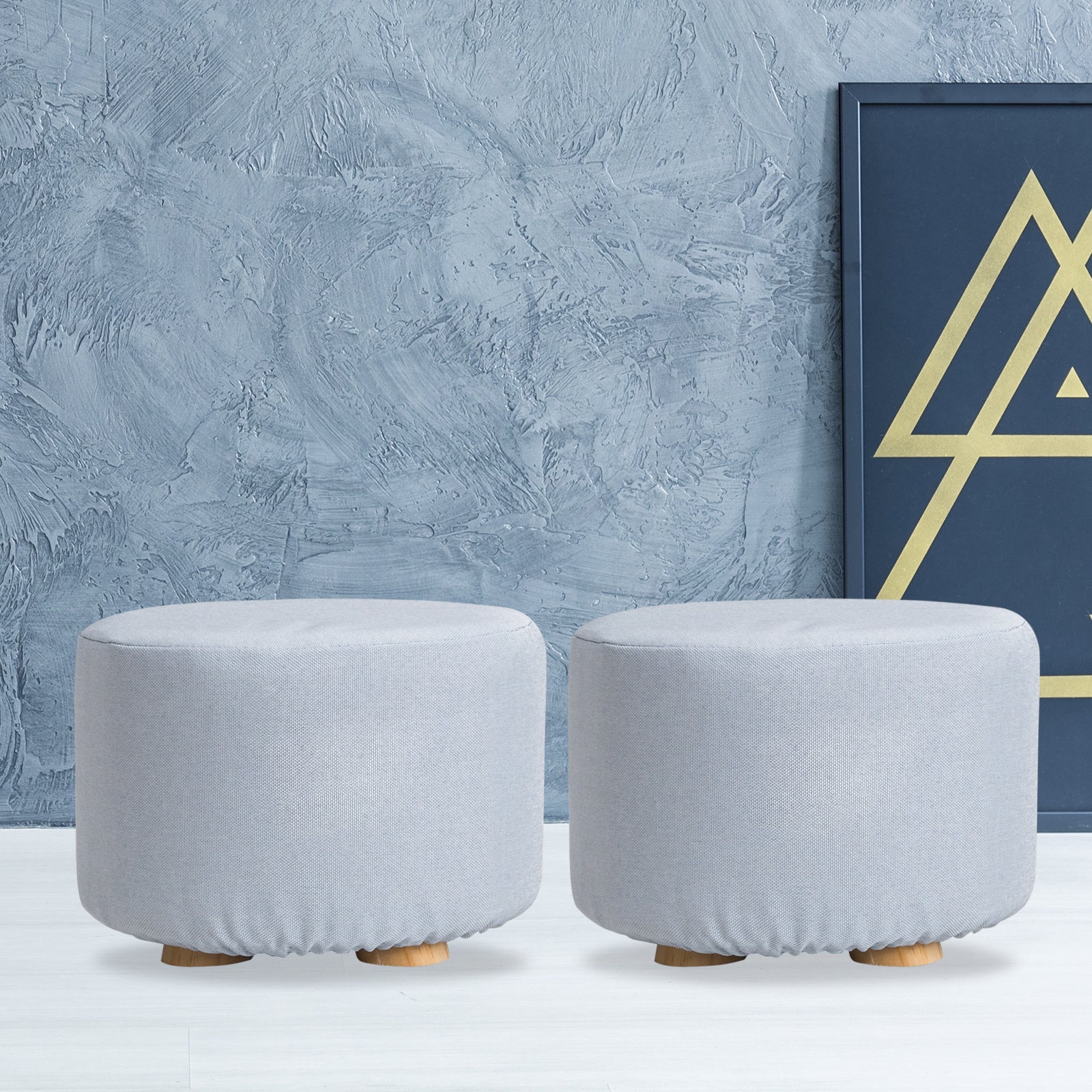Light blue round fabric ottoman footstool with wooden legs, cushioned top