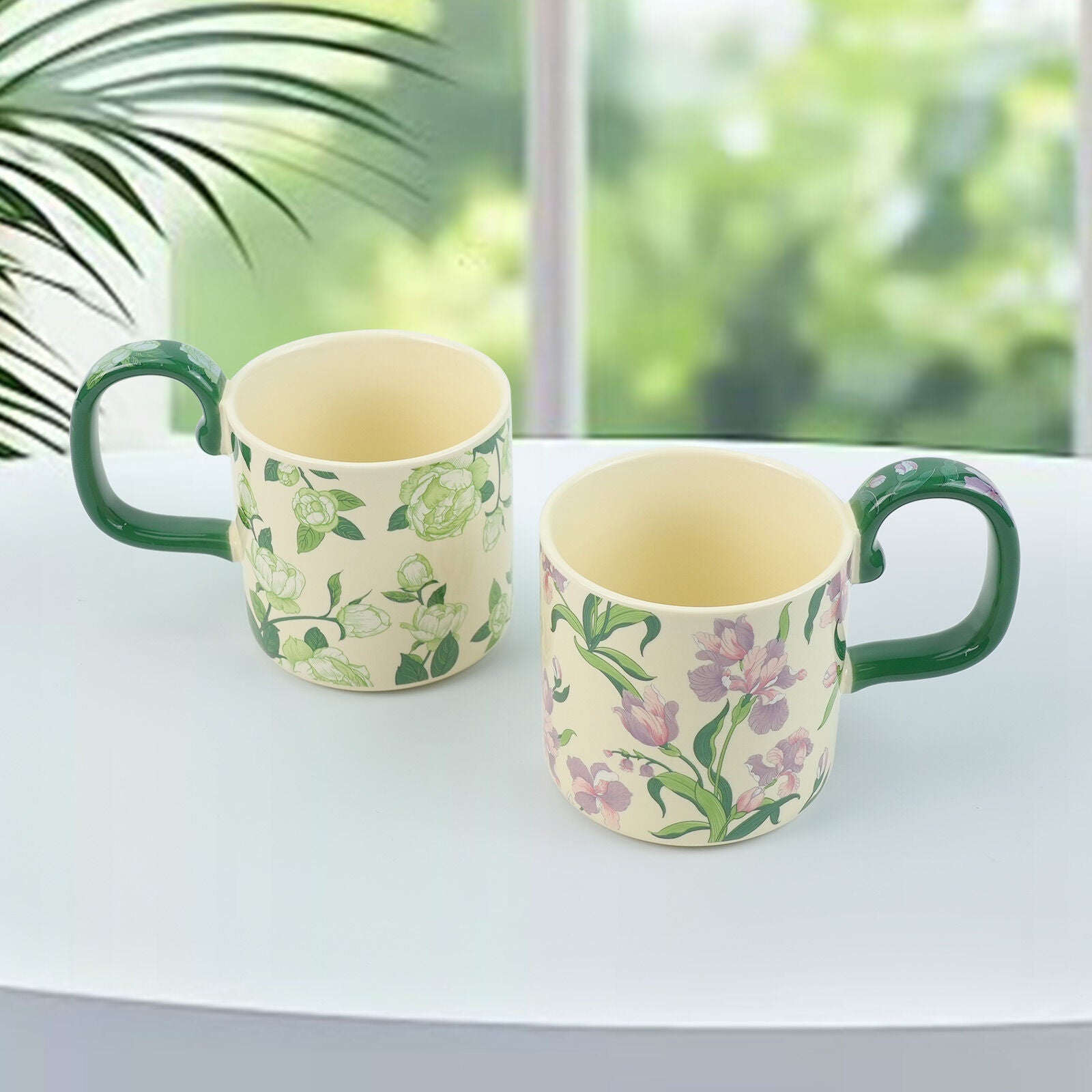 Two ceramic porcelain mugs with green handles and vintage floral prints