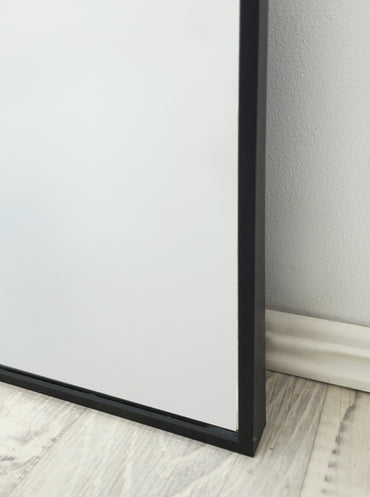 Arched wall mirror corner with black metal frame and glass panel