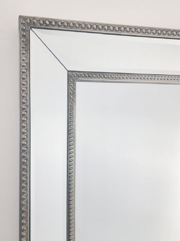 Silver beaded mirror frame corner with beveled glass edges
