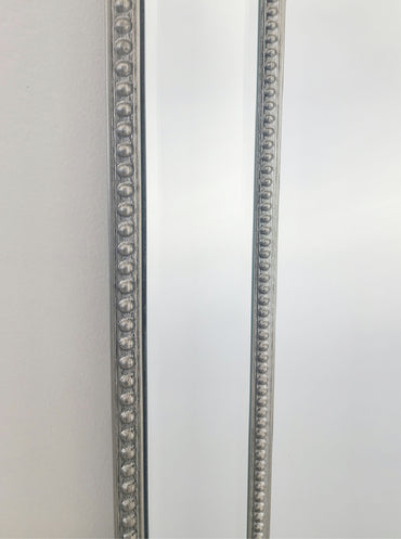 Silver beaded mirror frame with detailed bead trim along the side