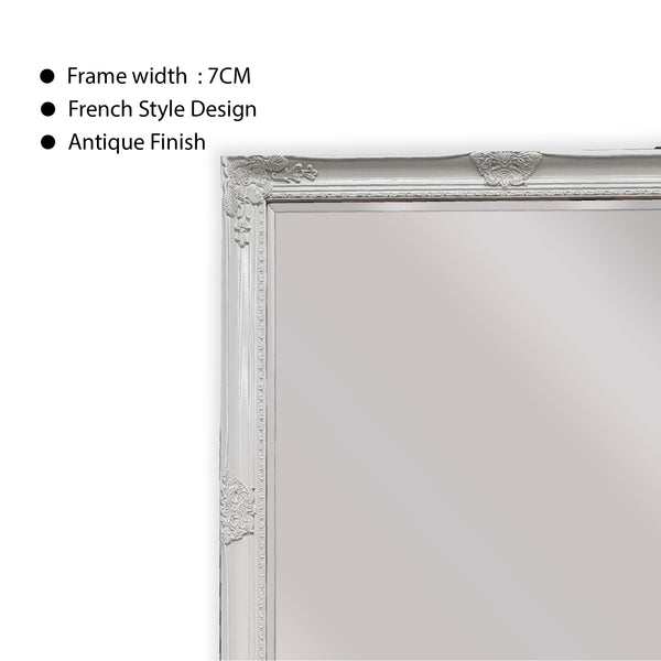 White ornate mirror frame close-up with French style detailing and antique finish