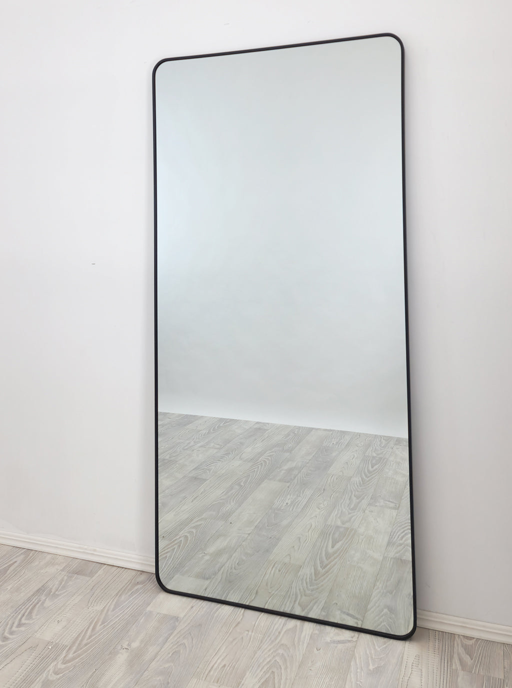Tall rectangle mirror with black metal frame and rounded edges