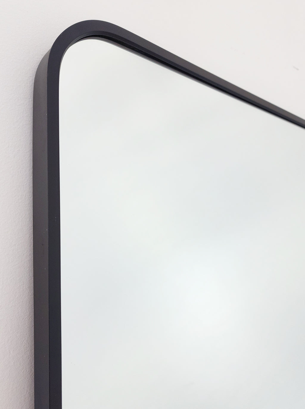 Black metal mirror frame with rounded corner edge and slim border