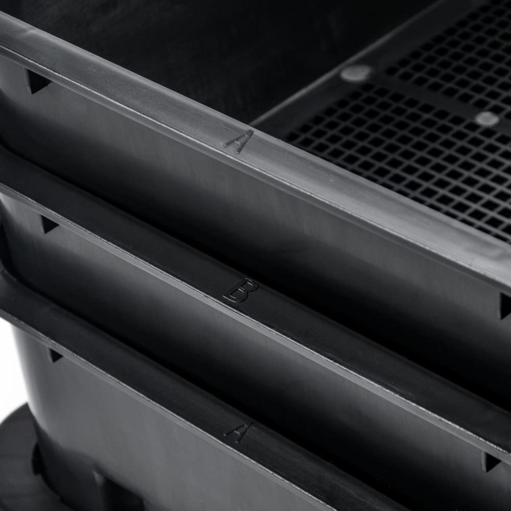 Close-up of black plastic worm composter tray edges and ventilation hole panel