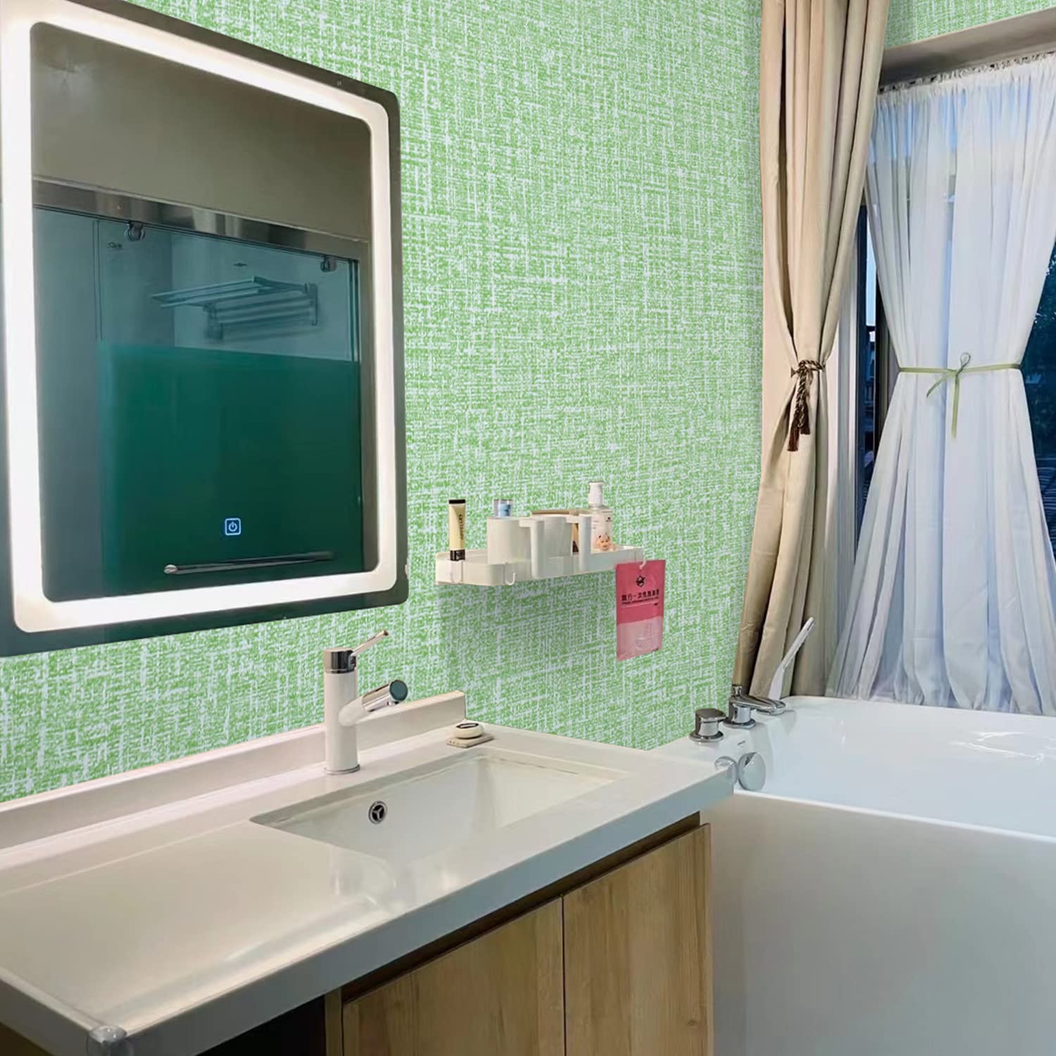 Green textured wallpaper on bathroom wall behind sink and mirror