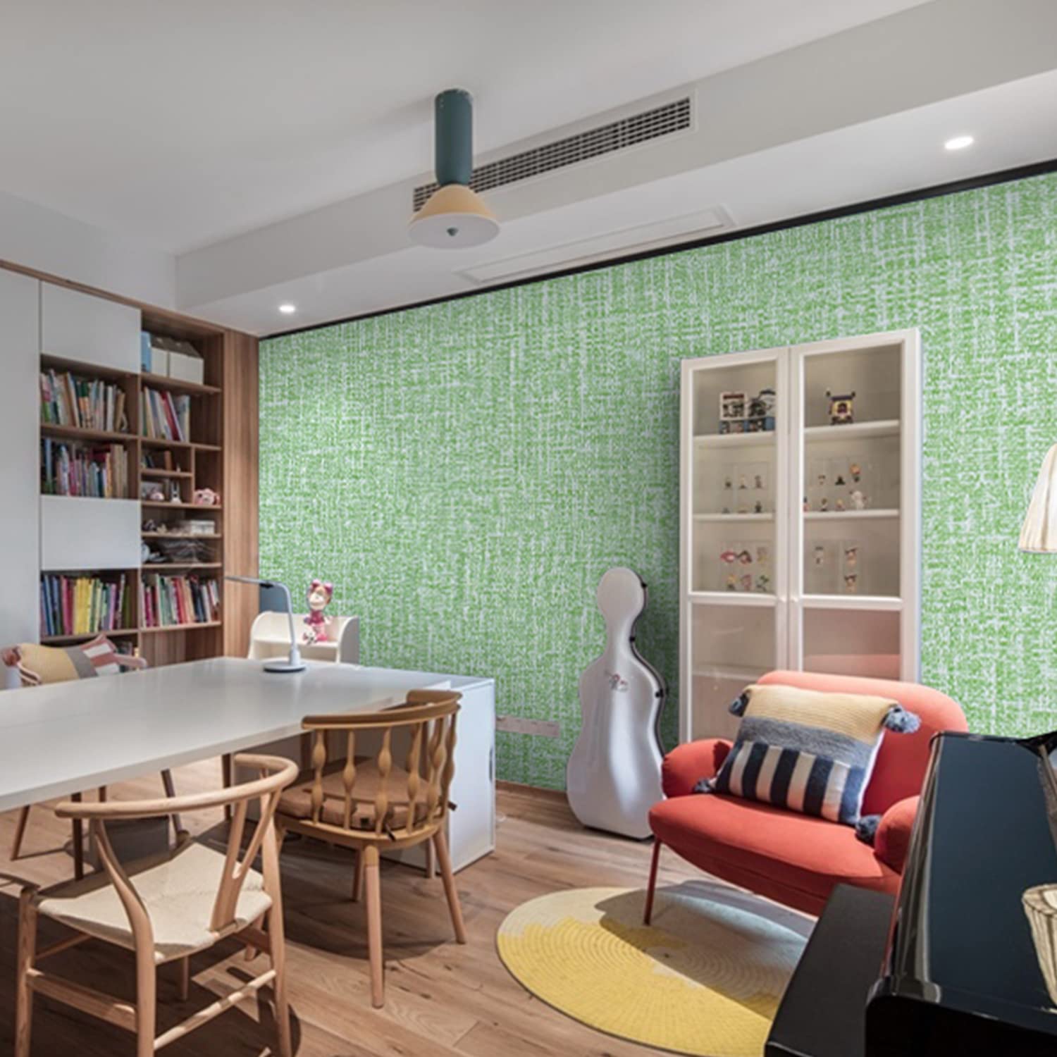 Green textured wallpaper on wall in living room with shelf and seating