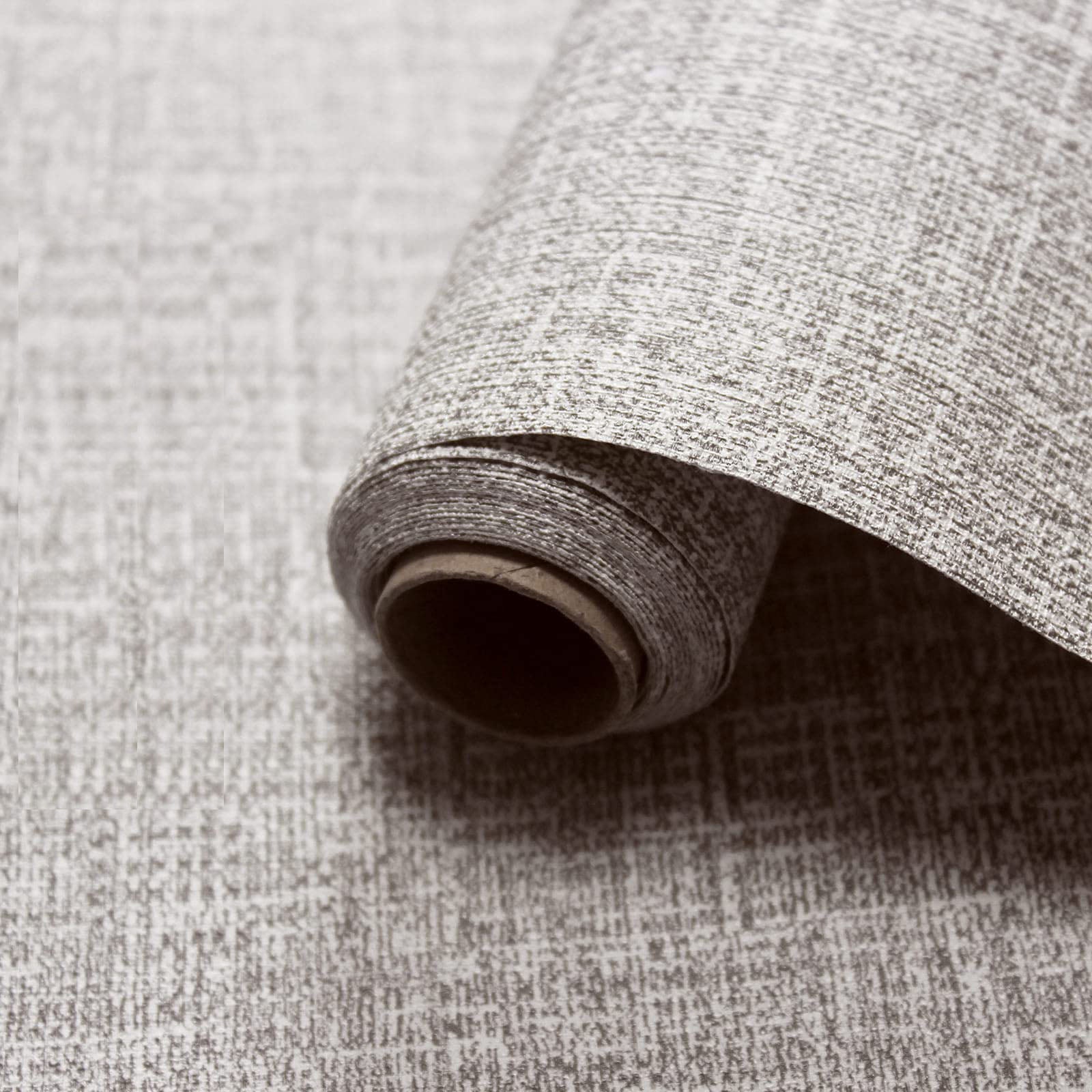 Faux grasscloth contact wallpaper roll in light grey, textured fabric-like weave