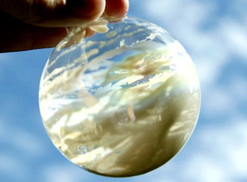Clear glass bauble with silver cap, reflective surface, round hanging ornament.
