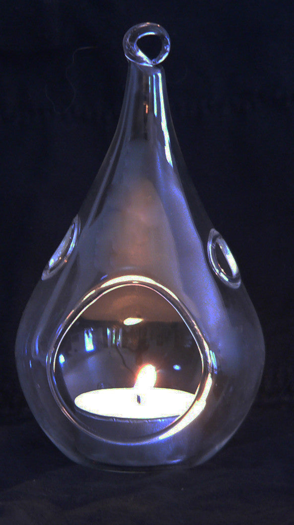 Clear teardrop glass candle holder with hanging loop and lit tealight inside