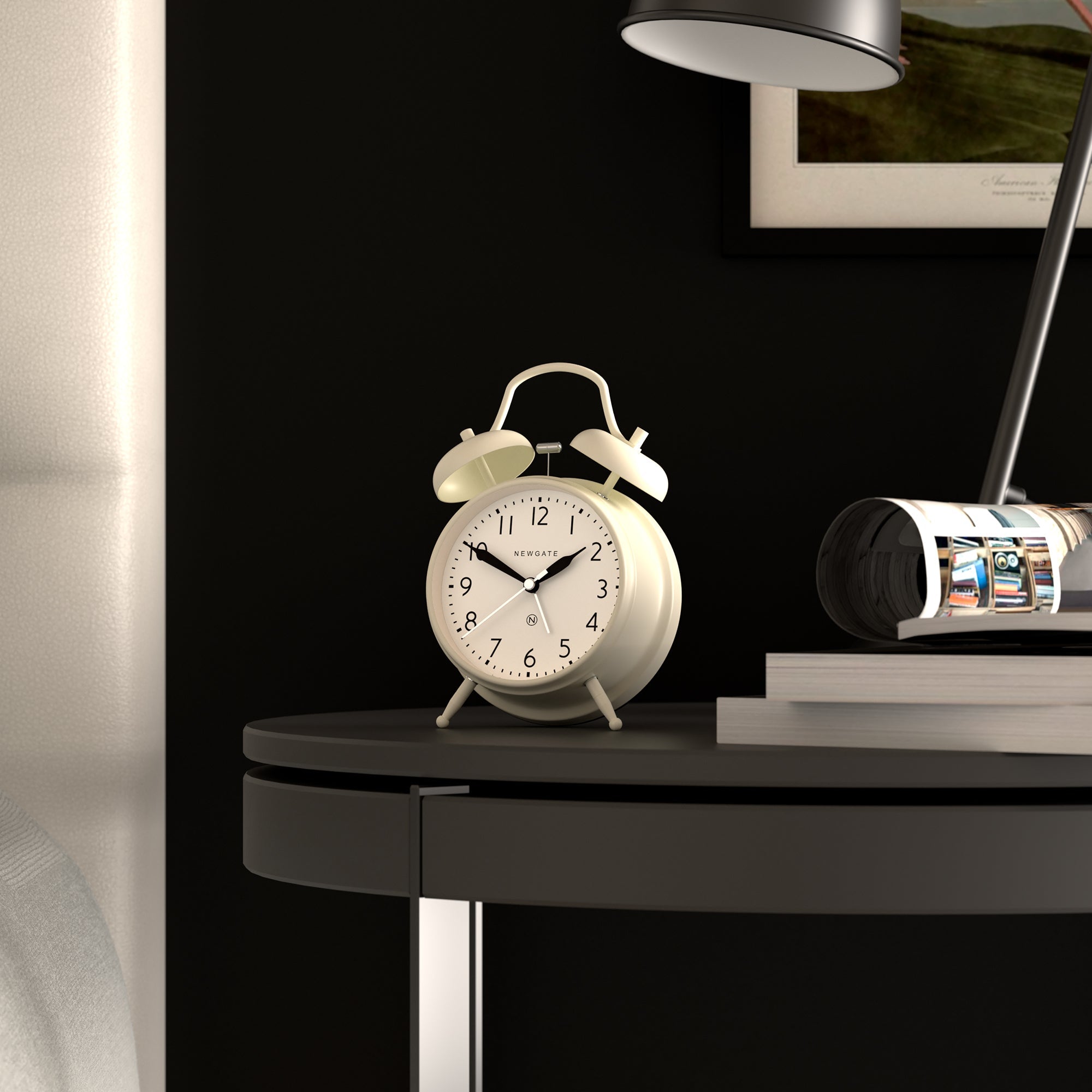 Linen white twin-bell alarm clock on a bedside table, Newgate dial.