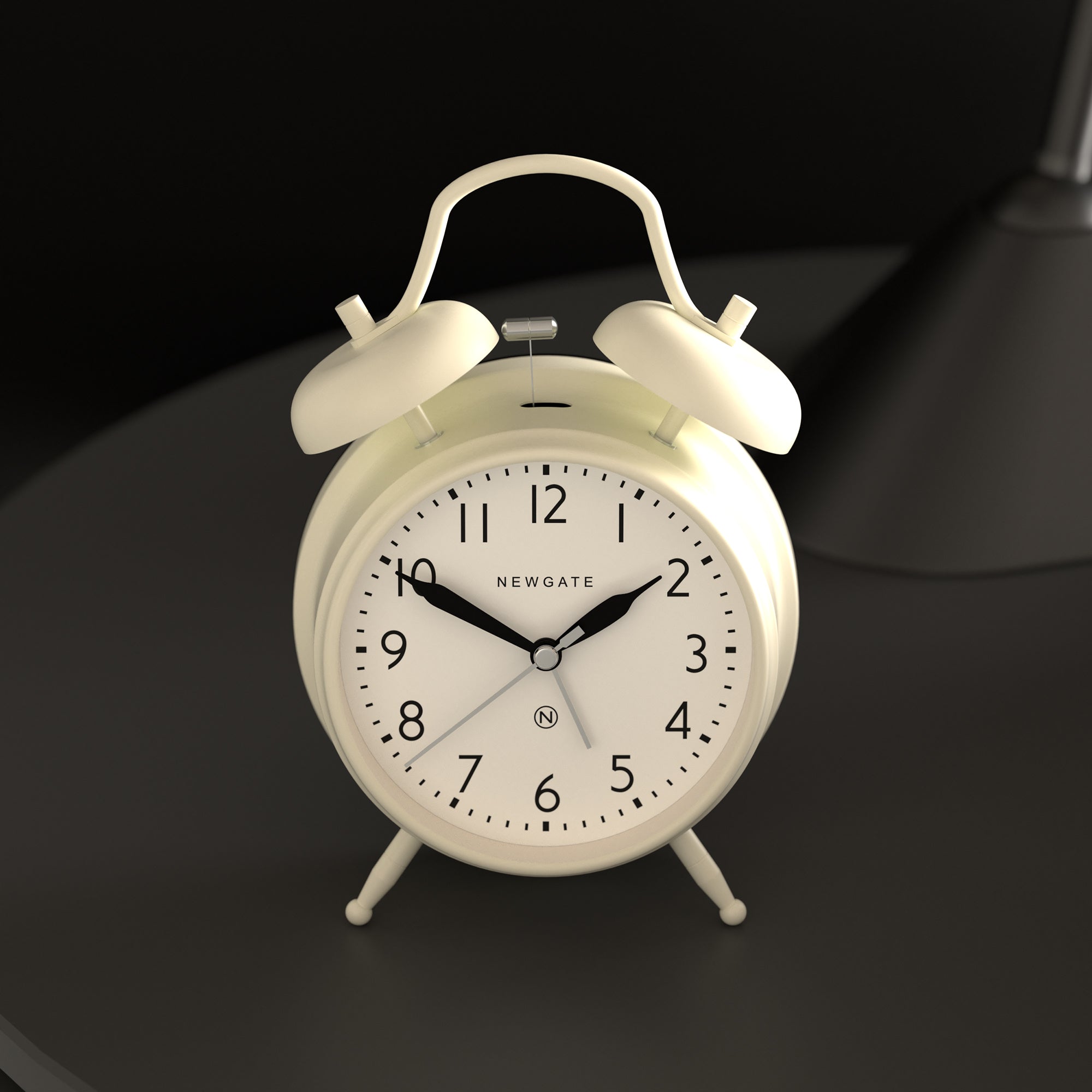 White twin-bell alarm clock with black hands and Newgate dial details.