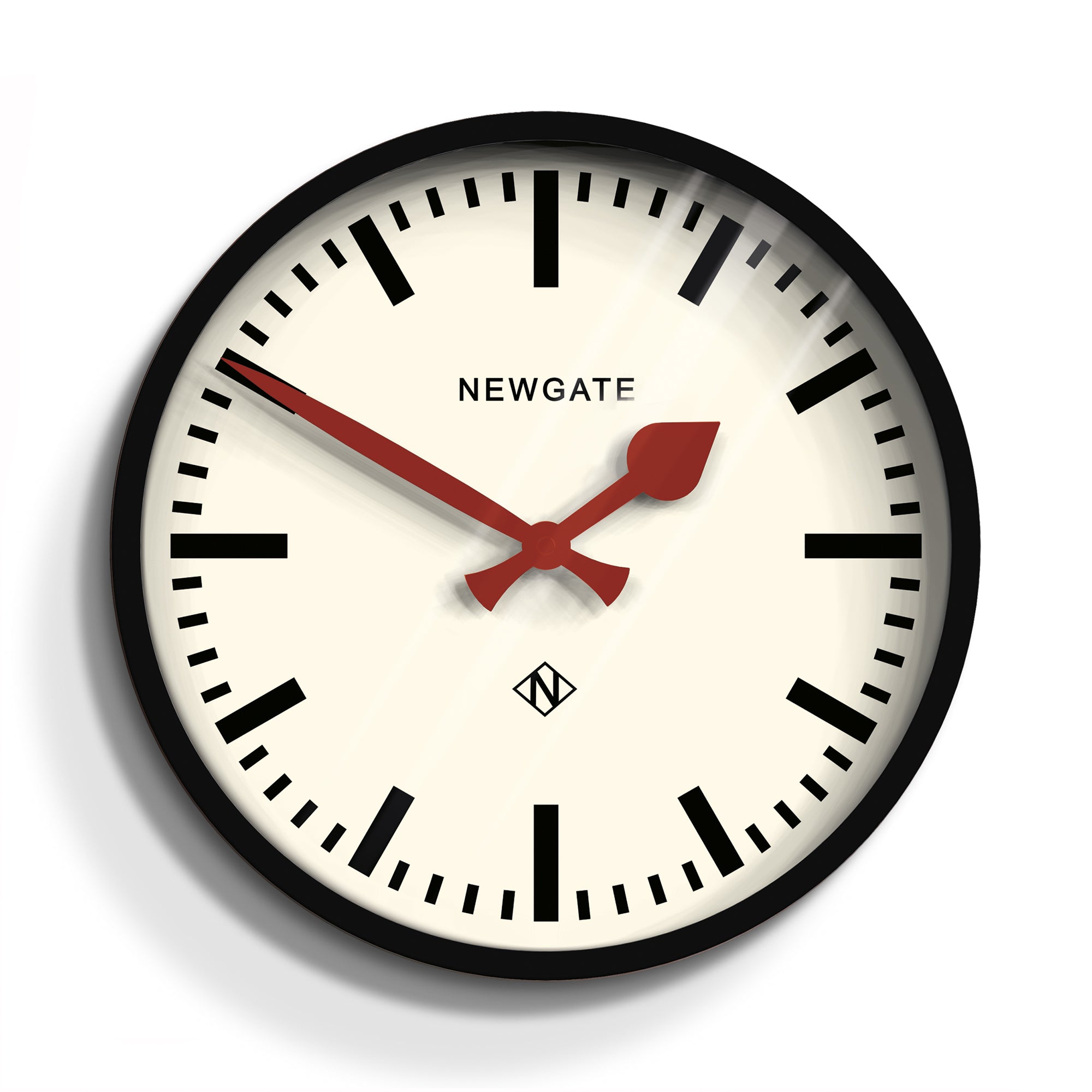 Black luggage clock with white face, red hands, and Newgate text, round frame