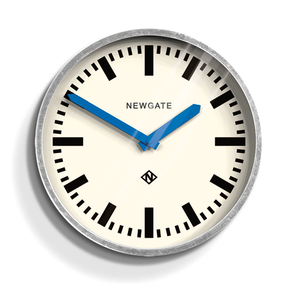 Wall clock with cream dial, black hour markers, and blue hands; galvanized silver rim