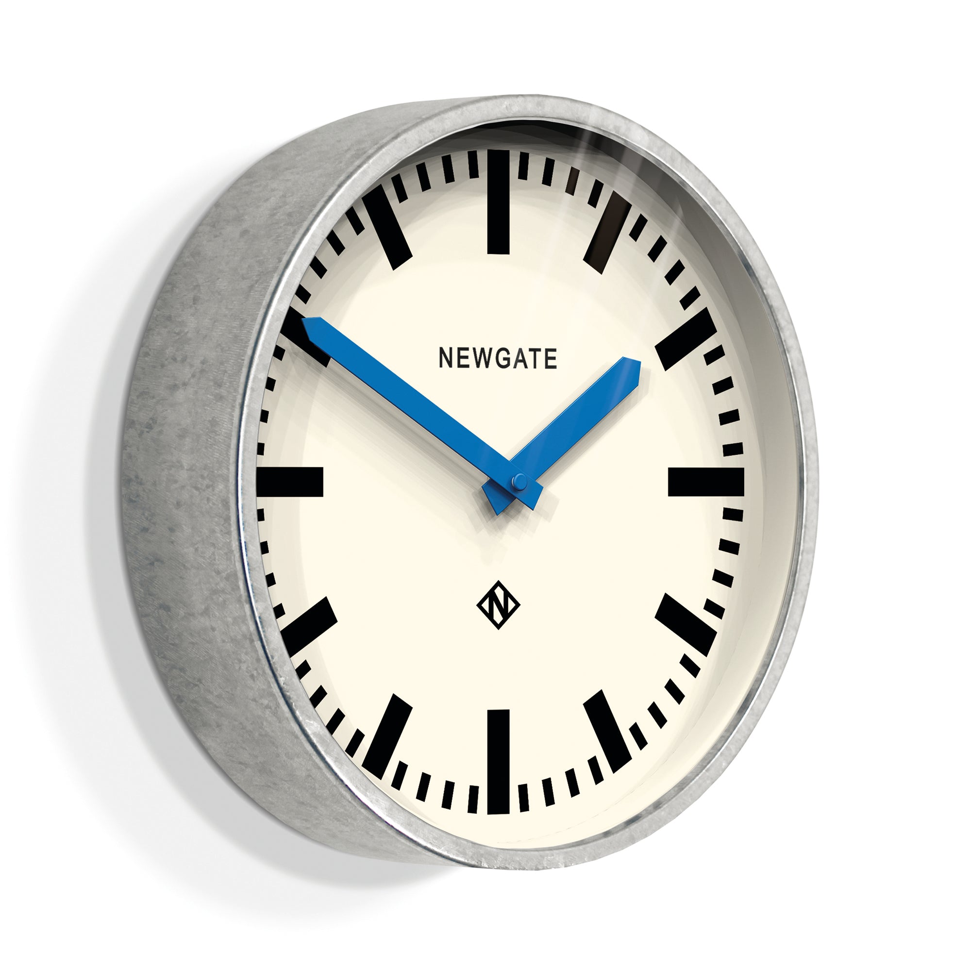 Wall clock close-up with cream dial, black markers, and blue hands under silver rim